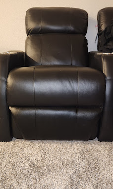 High-back home theater recliner rebuilt and reupholstered in black leather with clean double-stitched seams