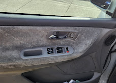 Finished car door interior panel wrapped in gray suede and matching vinyl with factory window controls reinstalled