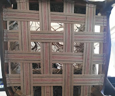 Vintage chair frame stripped to the wood with newly installed jute webbing and coil springs